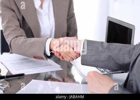 Business handshake. Two women lawyers are shaking hands after meeting or  negotiation.  Stock Photo