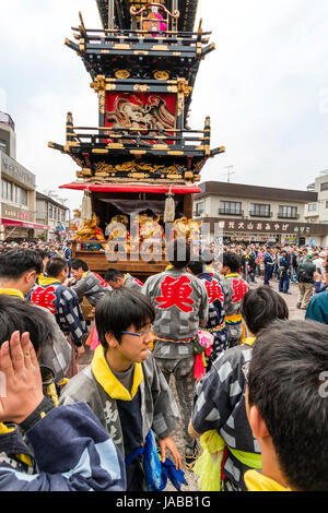 Inuyama festival in Japan, massive 3 storey wooden Dashi float, also called yatai or yama, in city square with spectators and Dashi team members. Stock Photo