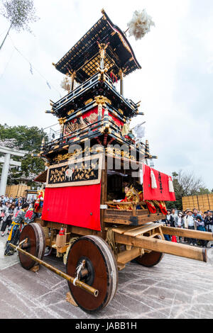 Inuyama festival in Japan, massive 3 storey wooden Dashi float, also called yatai or yama, in city square with spectators and Dashi team members. Stock Photo