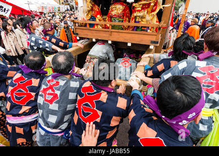 Inuyama festival in Japan, massive 3 storey wooden Dashi float, also called yatai or yama, being pushed through spectator crowded street Stock Photo