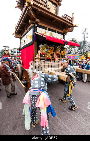 Inuyama festival in Japan, massive 3 storey wooden Dashi float, also called yatai or yama, being pushed through spectator crowded street Stock Photo