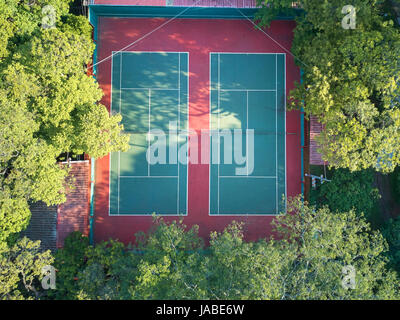 Aerial view on empty tennis courts in green trees park Stock Photo