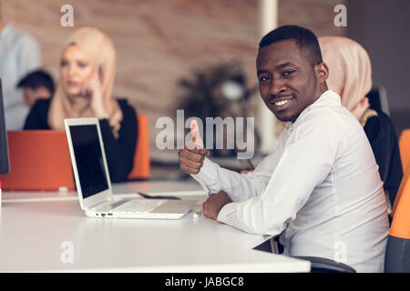 Multiracial contemporary business people working connected with technological devices Stock Photo