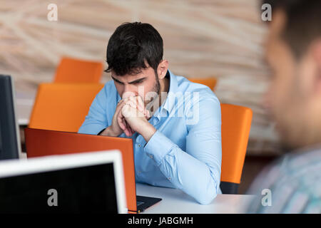 Worried businessman working at his desk in his office Stock Photo