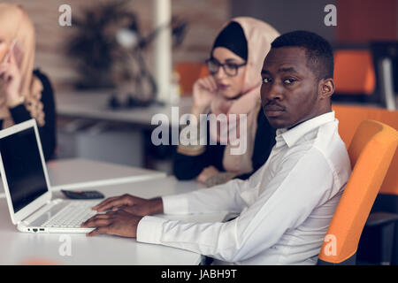 Multiracial contemporary business people working connected with technological devices Stock Photo