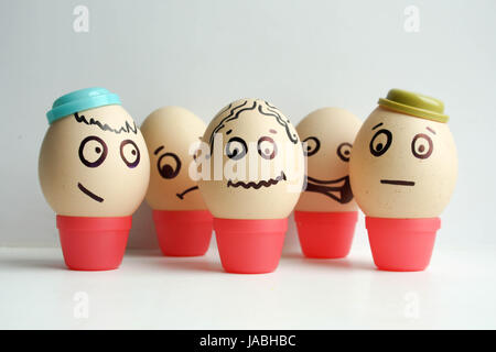 Eggs with painted face. Concept team. Funny faces in hats pics for your design Stock Photo