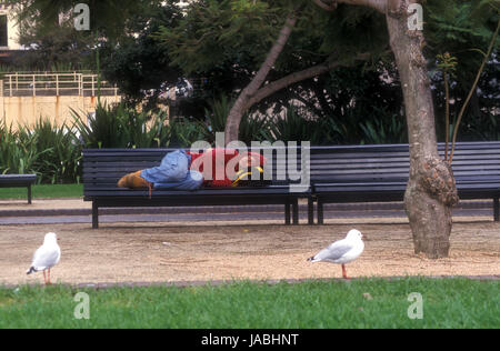Homeless teenager sleeping on a park bench in Brooklyn New York Stock ...