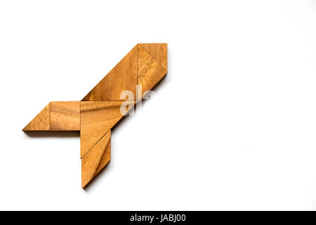 Wooden tangram puzzle in rocket shape on white background (Concept for new experience, start project) Stock Photo