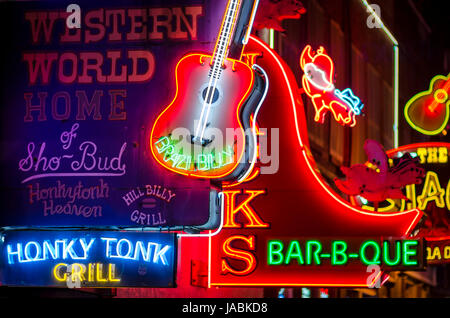 NASHVILLE - JULY 10, 2014: Bright neon signs of the city's honky tonk bar scene line the country music entertainment district of Lower Broadway. Stock Photo