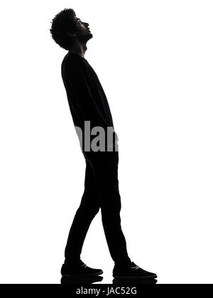 one african handsome young man standing looking up surprise   in silhouette studio isolated on white background Stock Photo