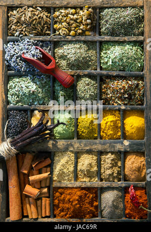Overhead view of a selection of mixed dried herbs, condiments and spices in an old wooden printers tray Stock Photo