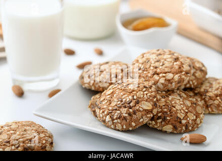 Still life with wholegrain biscuits milk and almonds Stock Photo