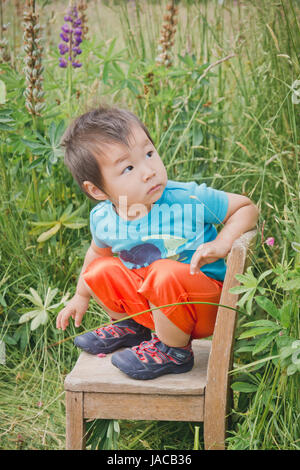 Boy in Orange Shorts Stock Photo