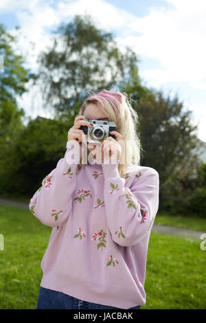 Young woman holding a 1950's Franka 35mm film camera Stock Photo