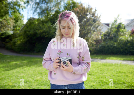 Young woman holding a 1950's Franka 35mm film camera Stock Photo