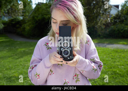 Young woman holding a  Microcord film camera Stock Photo