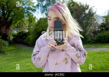 Young woman holding a  Microcord film camera Stock Photo