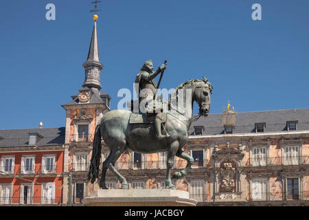 Bronze statue of King Philip III, surrounded by three storey houses with balconies, in the centre of Plaza Major, Madrid, Spain. Stock Photo