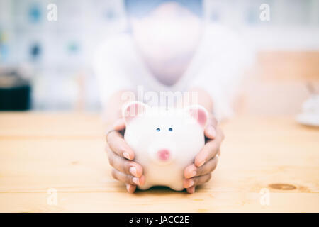 saving money,piggy bank saving,business saving money concept,business economy idea,selective focus and vintage color tone. Stock Photo