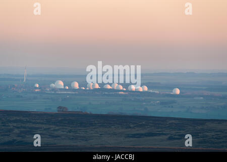 Under pink evening sky in the North Yorkshire countryside, white radomes of RAF Menwith Hill, Harrogate, look like giant golf balls. England, GB, UK. Stock Photo