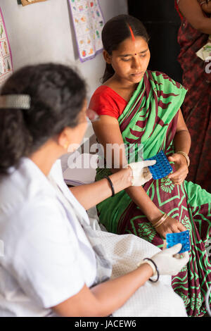 A pregnant woman receives a maternal health exam at a mobile clinic in ...