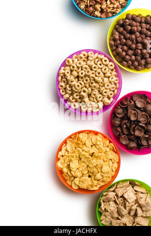 top view of various cereals in plastic bowls on white background Stock Photo