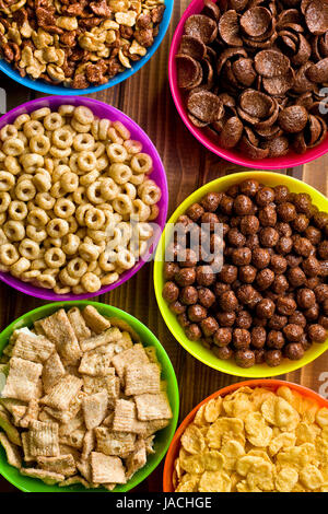 top view of various kids cereals in plastic bowls Stock Photo