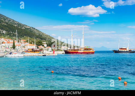 Port of Bol in Croatia with view on the town and historic cruising  ships anchoring Stock Photo