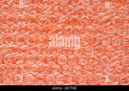 Orange air bubble wrap close up. Plastic surface of shock proof packing. Texture and background Stock Photo