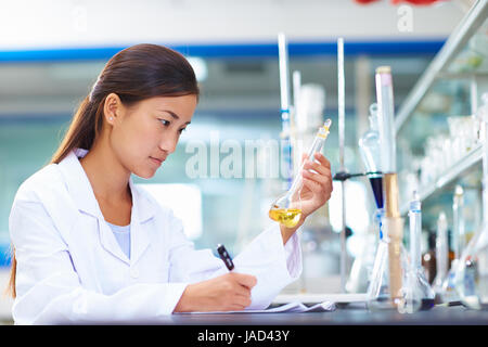 One Female Chinese Laboratory scientist working at lab with test tubes Stock Photo