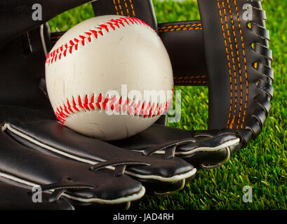 A baseball inside a baseball glove over white background Stock Photo