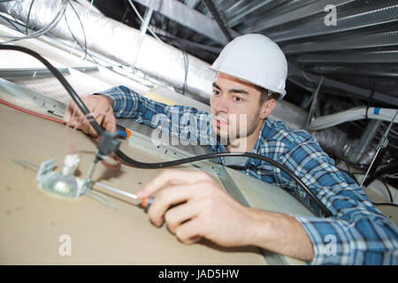 technician is checking servers wires in data center Stock Photo