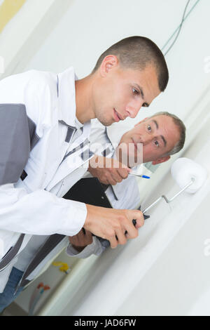 painter with apprentice and client Stock Photo