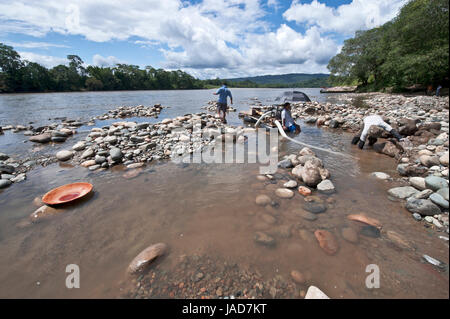 Misahualli, Napo Province, Ecuador - December 27, 2010: Local Indians People panning for Gold with wood batea (Spanish for 'gold pan'), in the Napo Ri Stock Photo