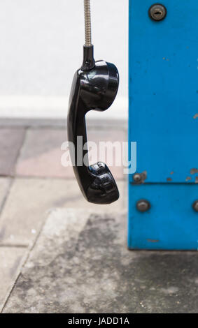 One black handset hanging in a row Stock Photo