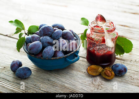 Plums and  marmelade on wooden background close up Stock Photo