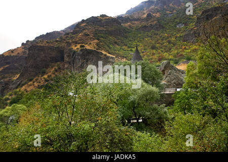 Geghard monastery and cliffs in Armenia. Cliffs surrounding Geghard monastery and Azat river gorge are included together with the monastery in the World Heritage Site listing. Stock Photo