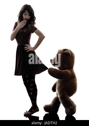 one caucasian strange young woman and vicious teddy bear  in silhouette white background Stock Photo