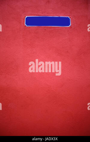 Color shot of an empty blue street sign on a red wall Stock Photo