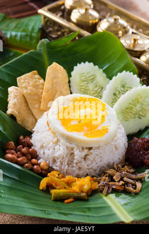 nasi lemak, a traditional malay curry paste rice dish served on a banana leaf Stock Photo