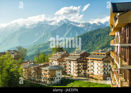 Mountain Village in the summer. Rosa Khutor, Sochi. Sun view of the plateau, hotel complexes and mountains. Stock Photo