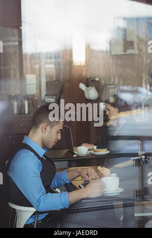 Businessman using digital tablet in office cafeteria Stock Photo