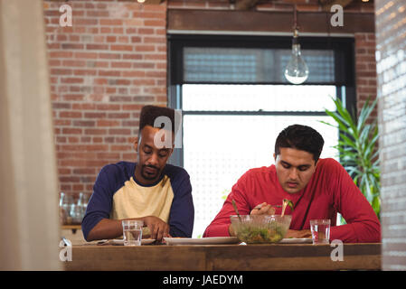 Gay couple having breakfast at home Stock Photo