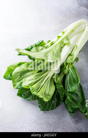 Fresh bok choy, chinese cabbage on gray stone background. Healthy food concept. Stock Photo