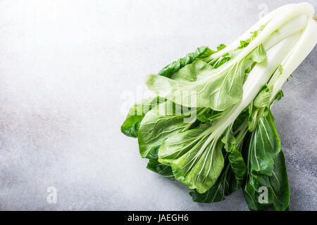 Fresh bok choy, chinese cabbage on gray stone background. Healthy food concept. Stock Photo