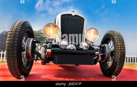 Front lower angle view of an unknown old-timer retro vintage sports car under blue sky Stock Photo