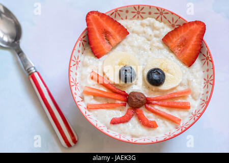 Oatmeal porridge with a kitten face decoration Stock Photo