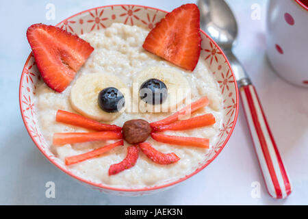 Oatmeal porridge with a kitten face decoration Stock Photo