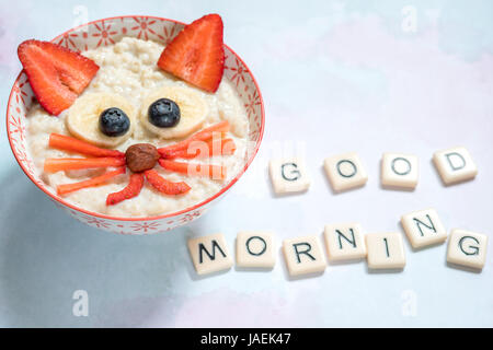 Oatmeal porridge with a kitten face decoration Stock Photo