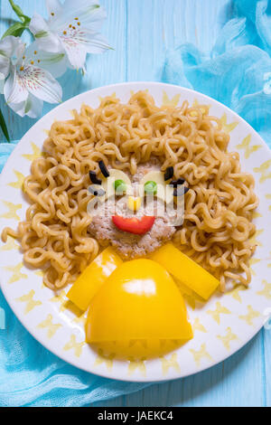 Funny Girl Food Face with Cutlet, Pasta noodles and Vegetables Stock Photo